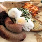 Poached egg on sourdough toast with sausage