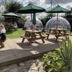 Outdoor seating and pods at the Twisted Spoon in Upton Snodsbury