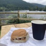 Sausage roll and cappuccino with a view at the Well of the Seven Heads takeaway