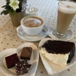Brownie selection, chocolate Guinness cake, cappuccino and latte at The Loose Box cafe at Barton Court in Colwall