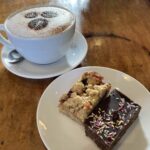 Peanut butter & jam oatie, tiffin and cappuccino at Roots Coffee & Community in Gloucester