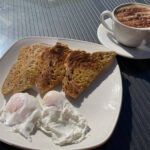 Cappuccino and poached eggs on toast at Hiller's Farm Shop & Cafe near Alcester