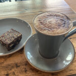 Cappuccino and fruit & nut brownie at The Sober Parrot cafe in Cheltenham
