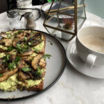 Avo & mushroom on toast with a cappuccino at The Happy Shroom cafe in Gloucester