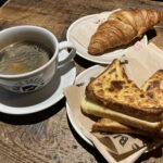 Coffee, cheese toastie & butter croissant at Black Sheep Coffee House in Deansgate, Greater Manchester