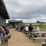 Outdoor seating at the Diddly Squat farm shop 'big view' cafe