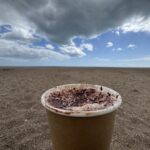 Cappuccino with beach view at Strete Gate coffee